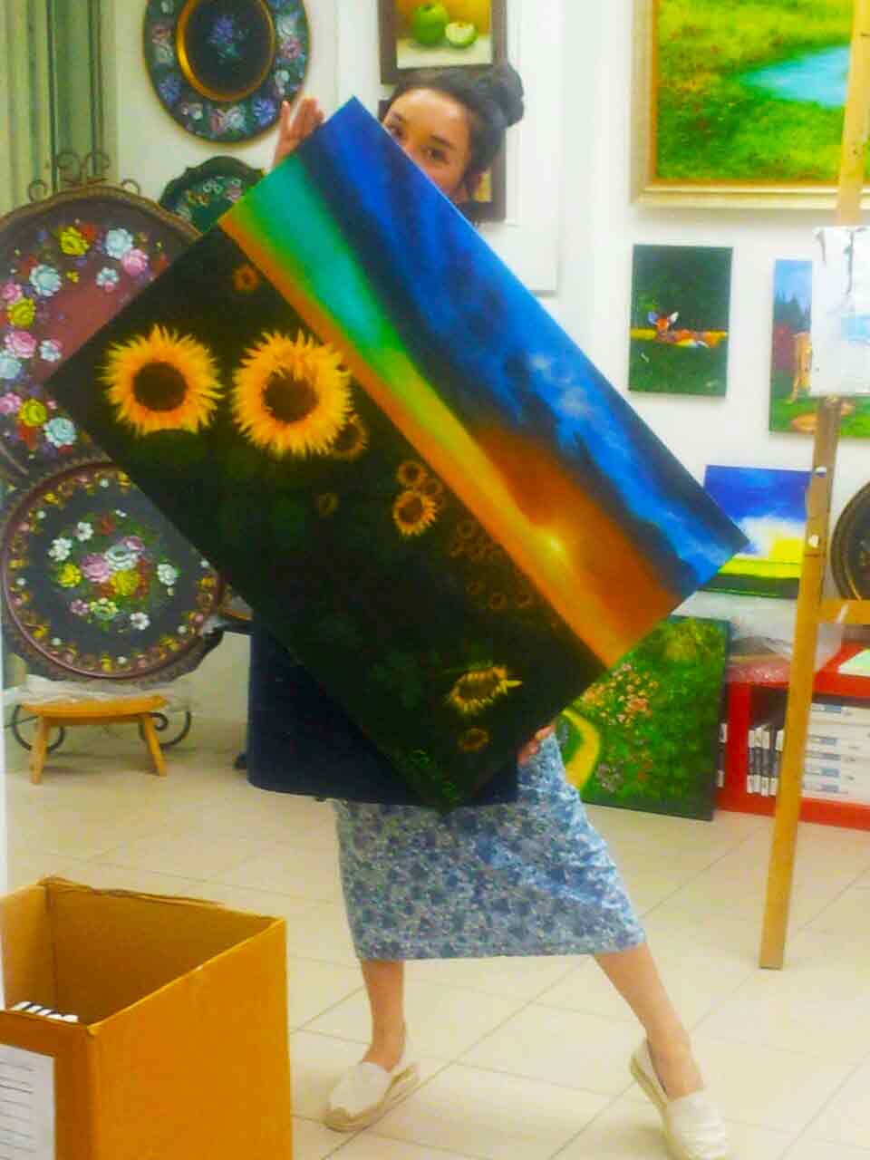Art Therapy - happy girl behind painting